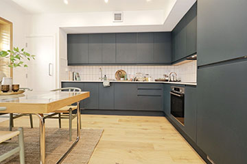 Burnholme Green internal photo showing a kitchen with dark grey units, tiles splash backs and white walls.