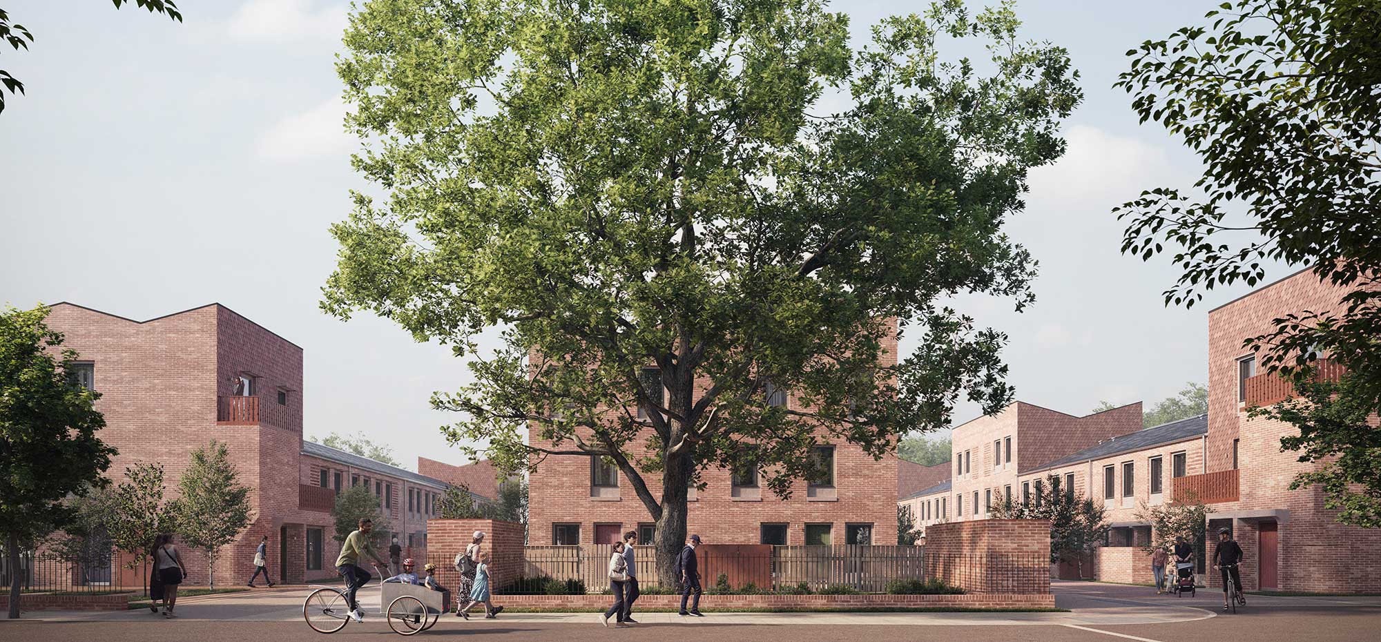 A panoramic view of the development shows the different types of properties. A large tree stands in the centre of the image. People are cycling on a footpath.