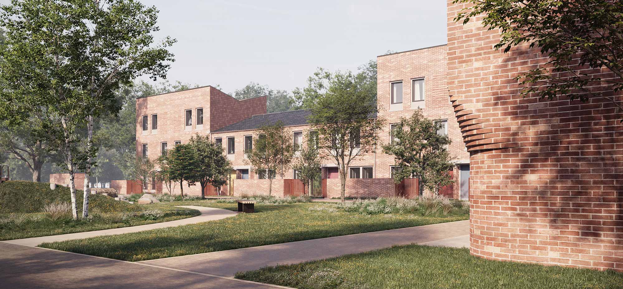A row of new houses and apartments. Trees and grass are growing in front.